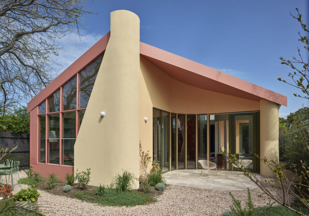 The outside view of a Vibrant renovation in Brunswick featuring curved glass timber windows by Pickering Joinery