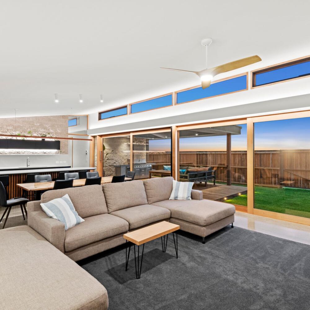 Modern Design home living area with large glass windows to view the backyard.
